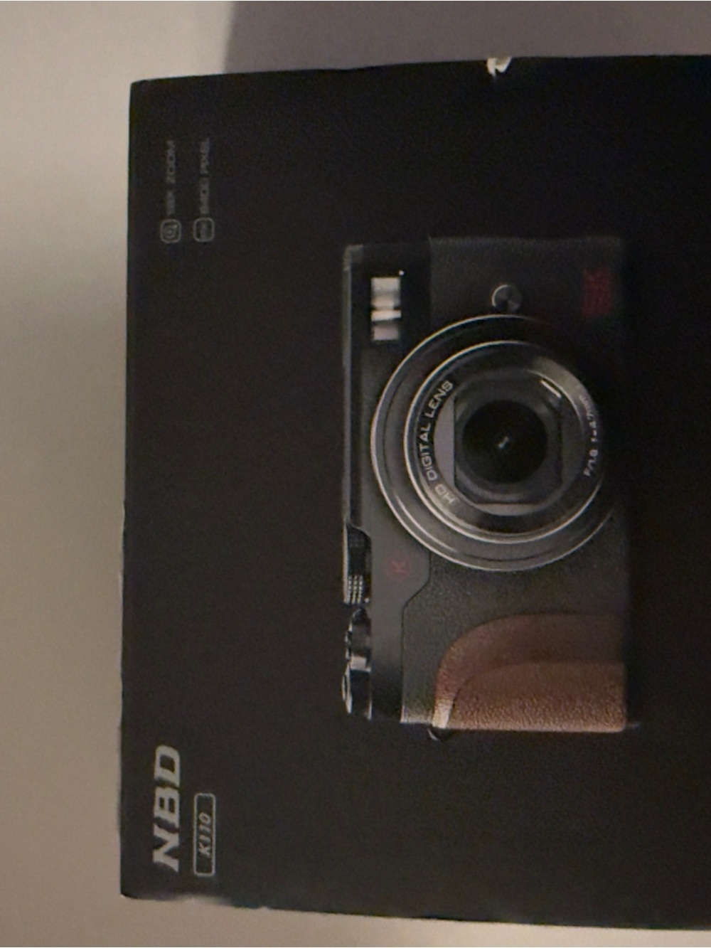 Compact Black Camera with Brown Grip